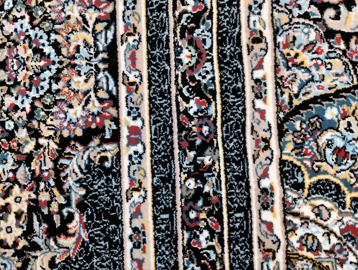 Close-up of the Azrinah ivory medallion carpet showing detailed ornamental motifs in dusty blue, blush pink, rust, muted gold, and dark navy-black.