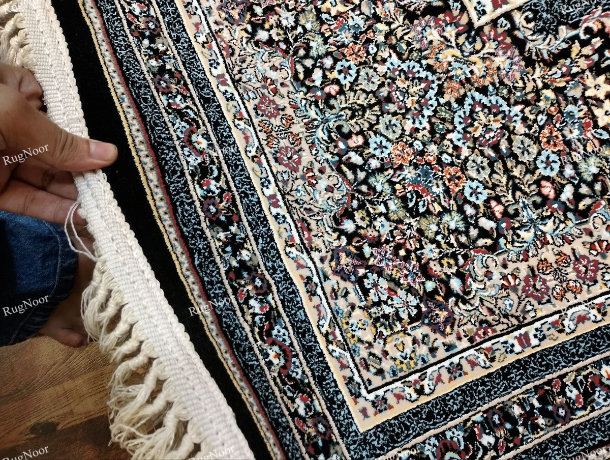 Detailed view of the Azrinah carpet's ivory and beige ground, dark outlined medallion motifs, and intricate decorative border.