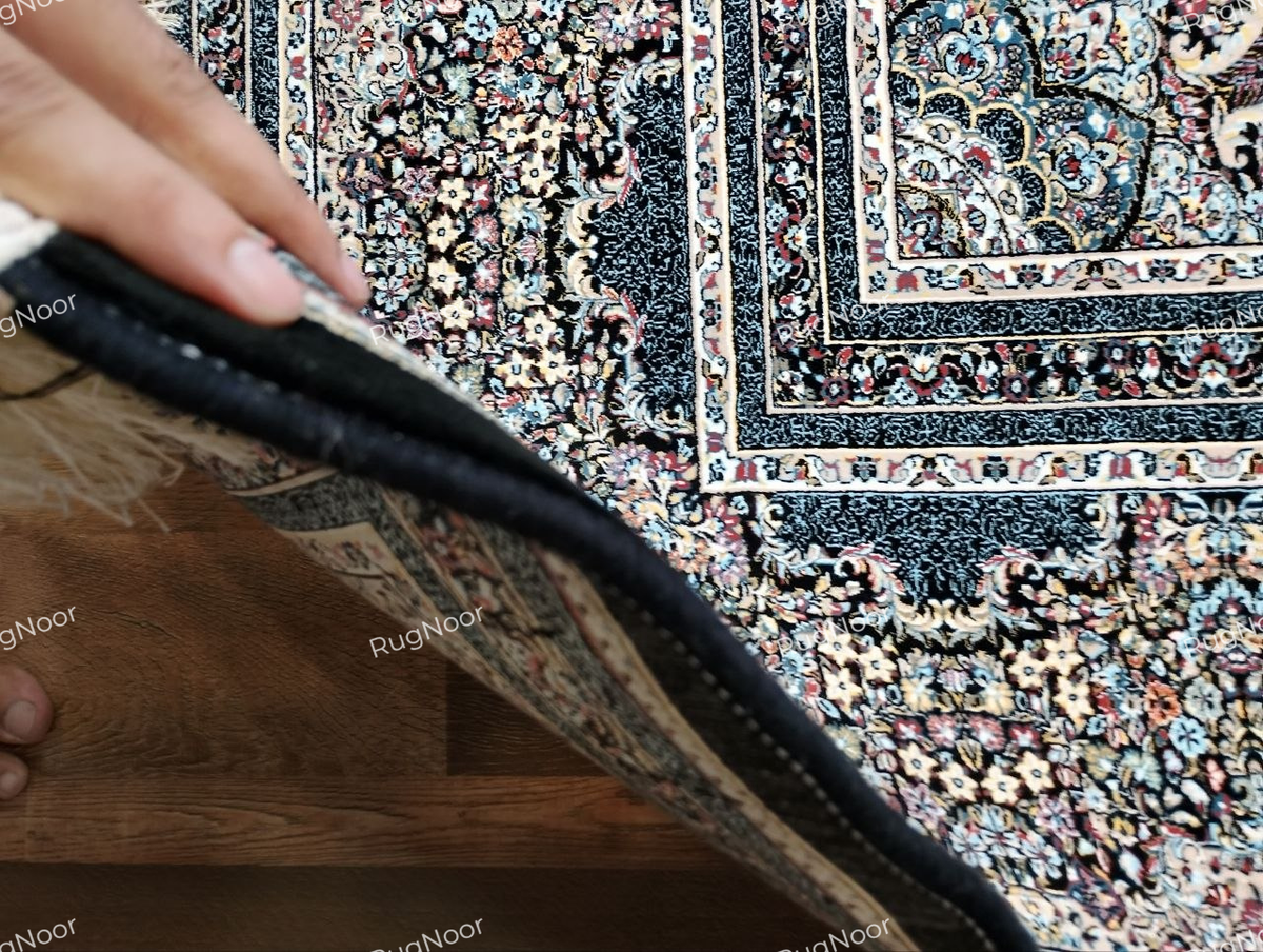 Detailed view of the Azrinah carpet's ivory and beige ground, dark outlined medallion motifs, and intricate decorative border.