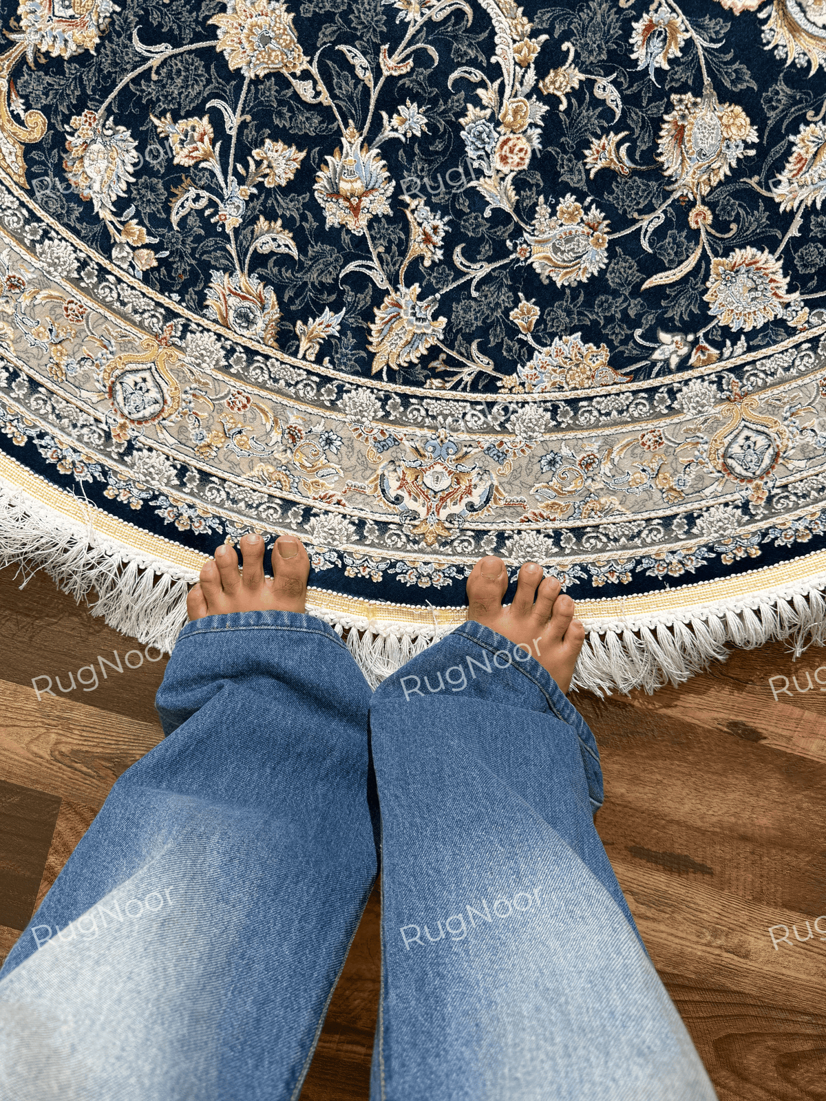 Fawaniya navy blue floral rug showing its ornate border and ivory fringe detailing.