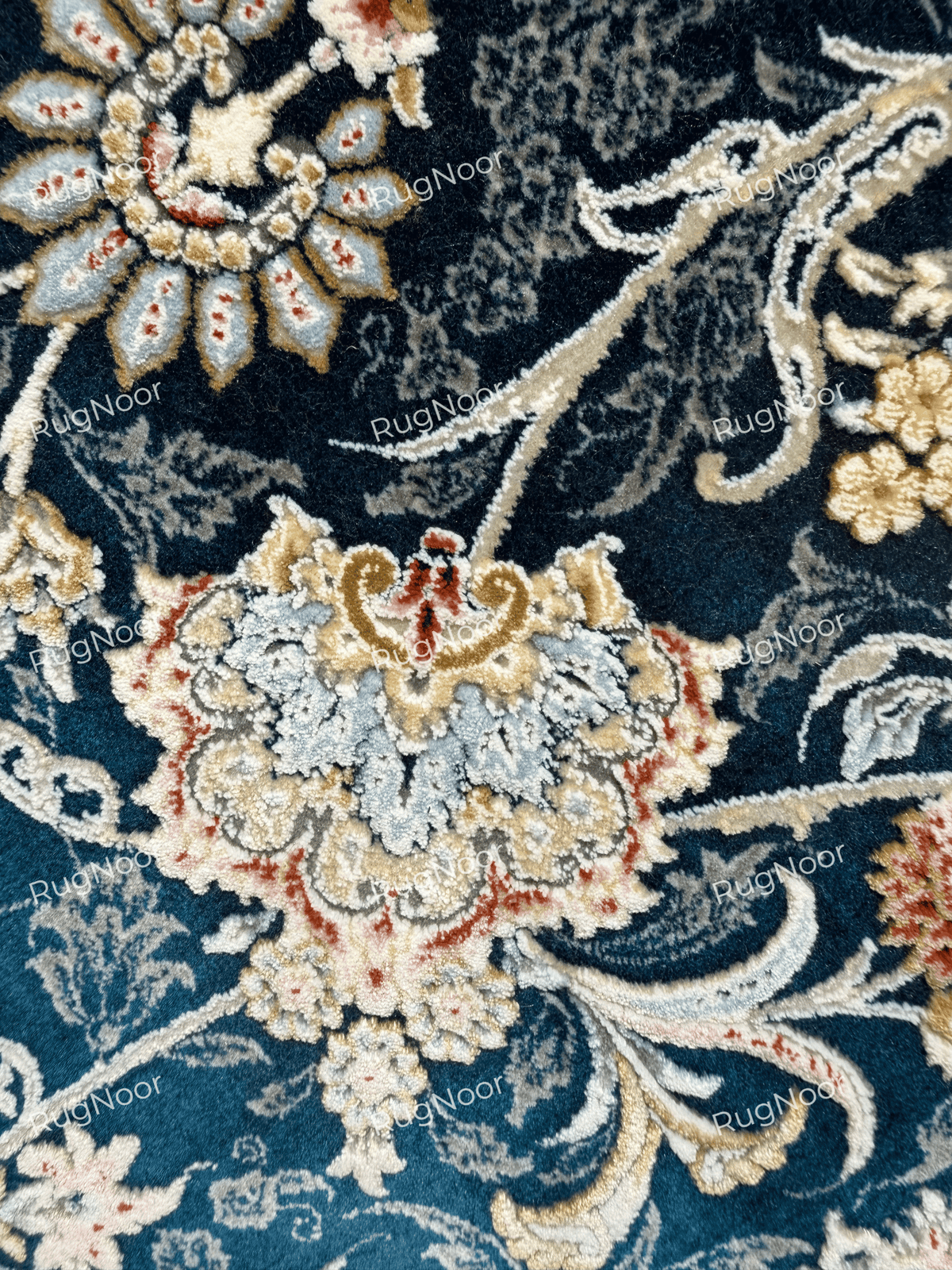 Close-up of the Fawaniya round rug showing intricate ivory and multicolour floral motifs on a navy blue background.