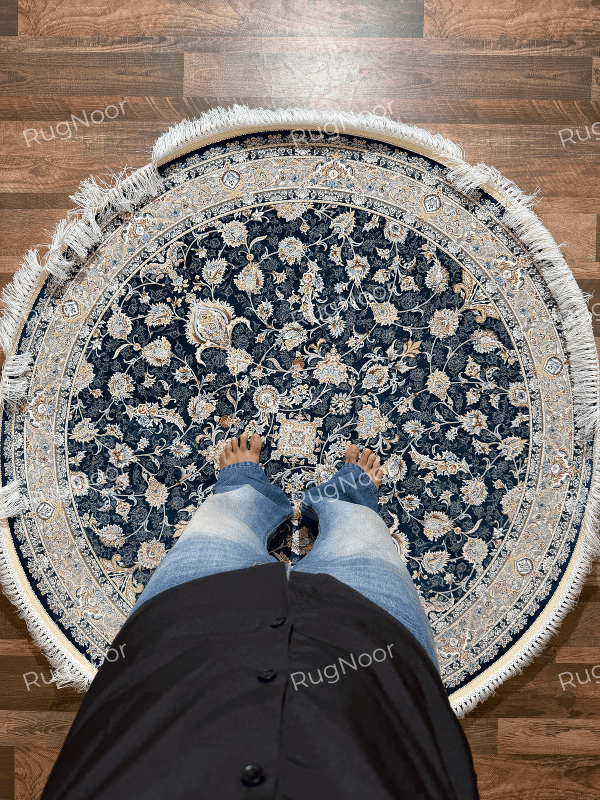 Fawaniya navy blue round floral rug shown on the floor to illustrate its pattern and appearance in a room.