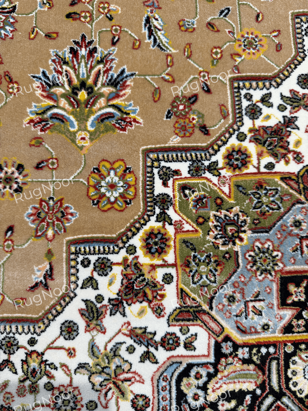 Close-up of a large multicolour floral motif and smaller scattered flowers on the camel-beige field beside the stepped ivory border and geometric floral detailing.