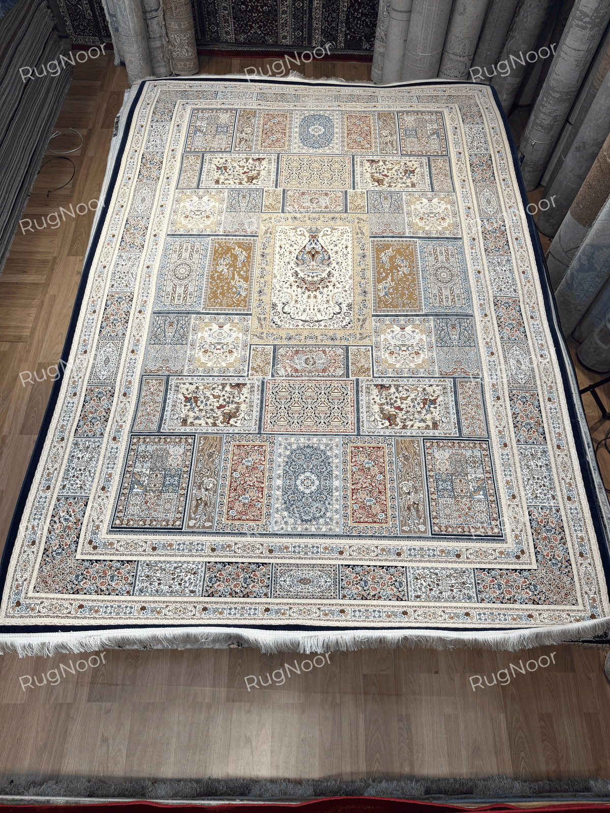 Full view of the Arghavan rectangular carpet displaying its central floral panel, multicolour framed sections, outer border, and ivory fringe.
