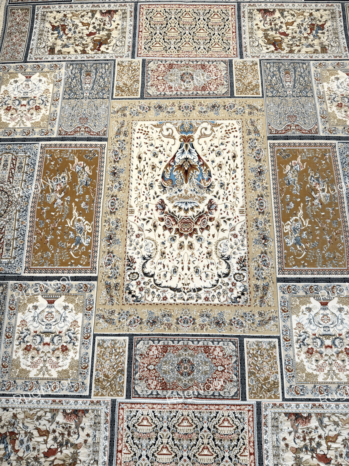Arghavan carpet showing its central ivory floral panel surrounded by framed floral and geometric sections in antique gold, dusty blue, rust, and burgundy.