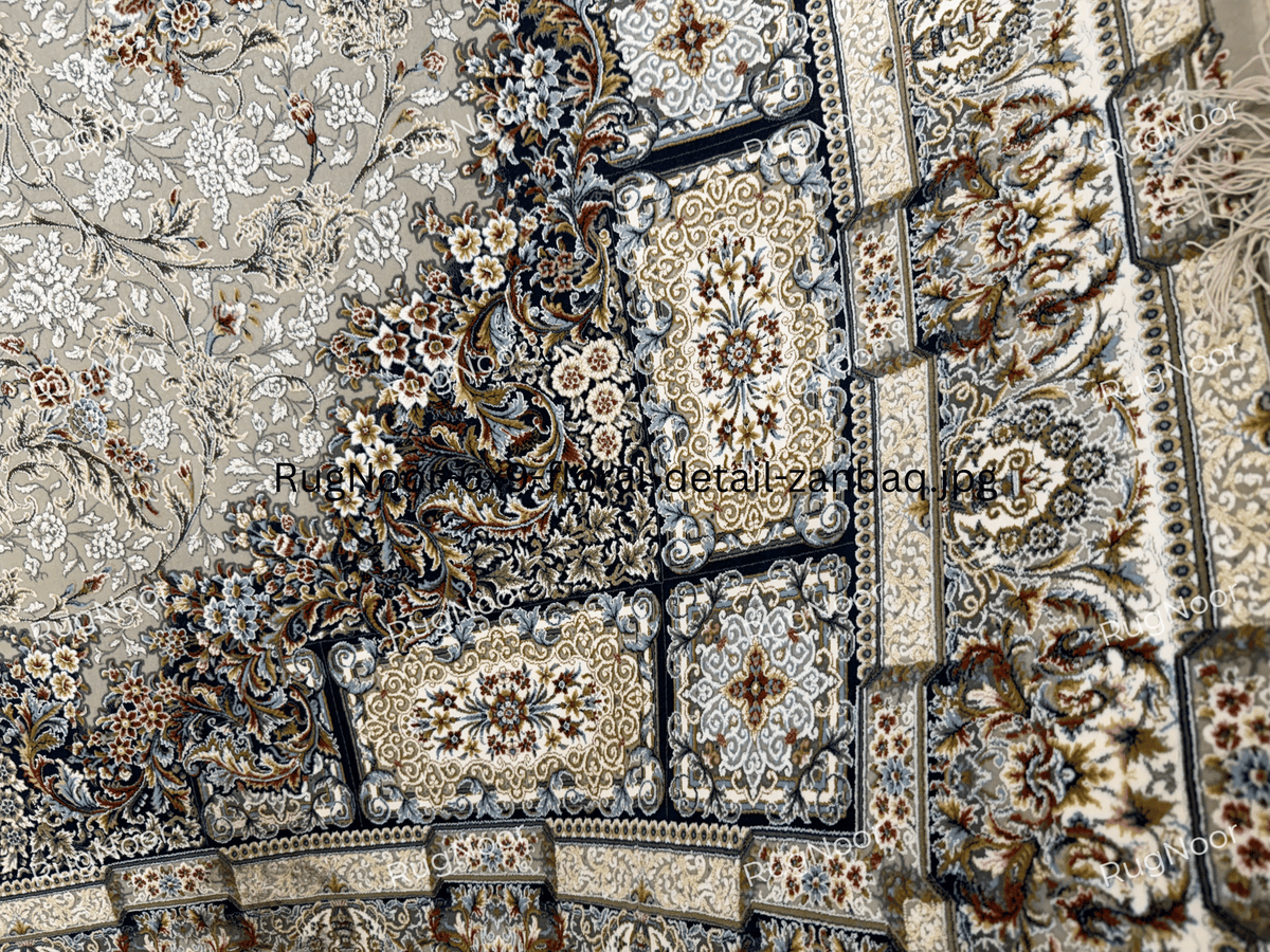 Detailed view of the navy and antique-gold border with framed floral panels on the Zanbaq carpet, RugNoor.