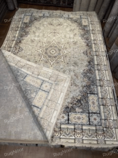 Carpet folded over to show its surface and reverse side, RugNoor.