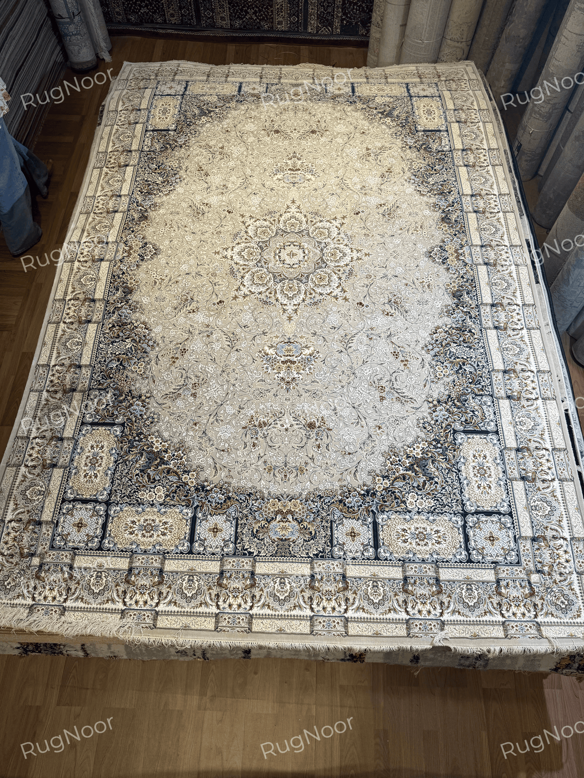 Full view of a light ivory-grey traditional floral carpet spread on the floor, RugNoor.