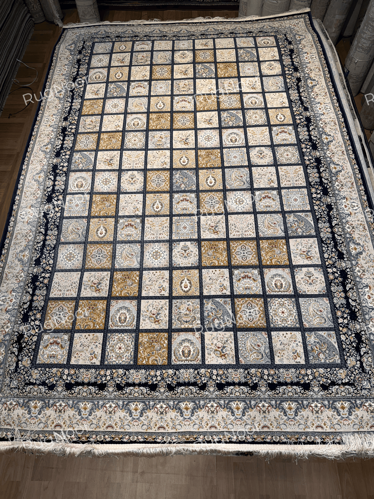 6x9 Parnian floral panel carpet with a dark navy border and ivory fringe.