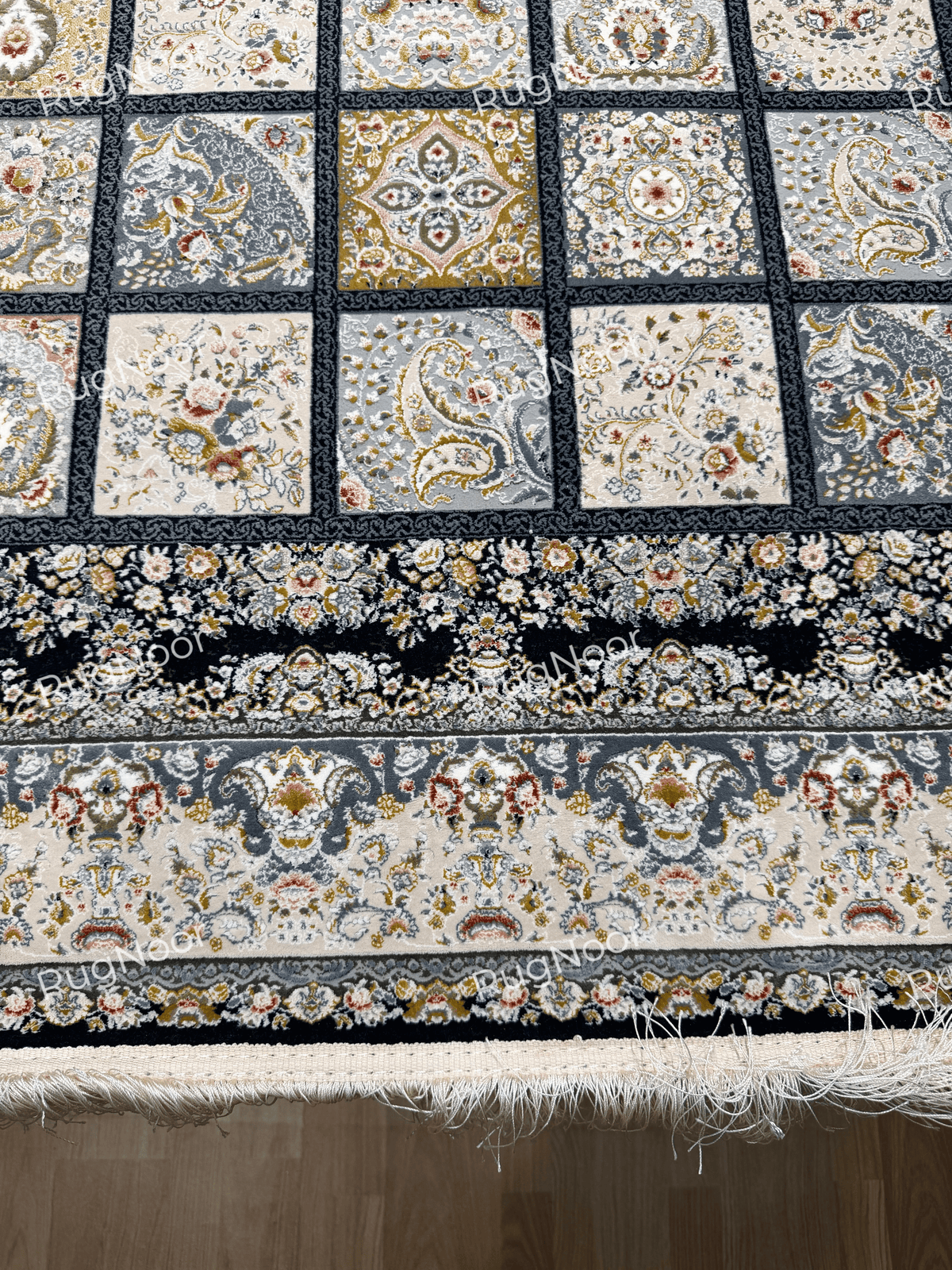 Detailed view of Parnian's decorative panels, navy edging, and ivory fringe.