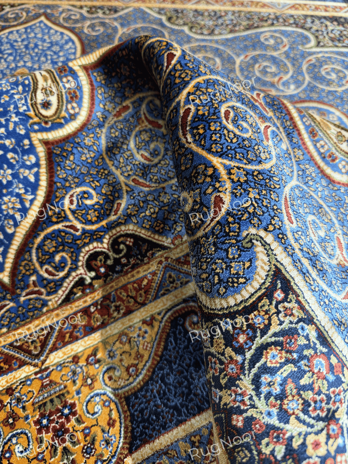 Yasamin rug- blue floral surface with fine detailing and ornate curved motifs.