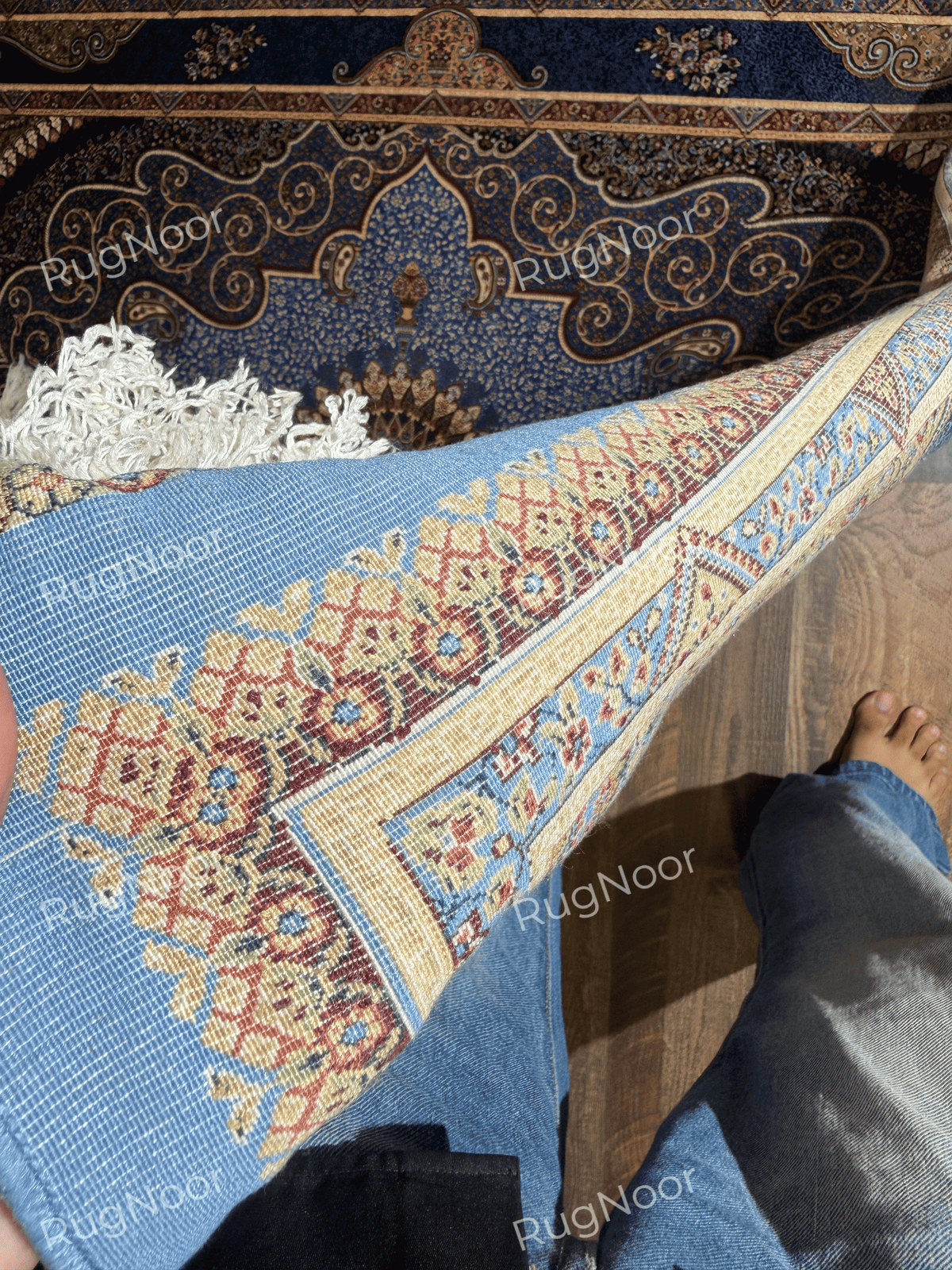 Yasamin underside showing its blue backing and patterned border.