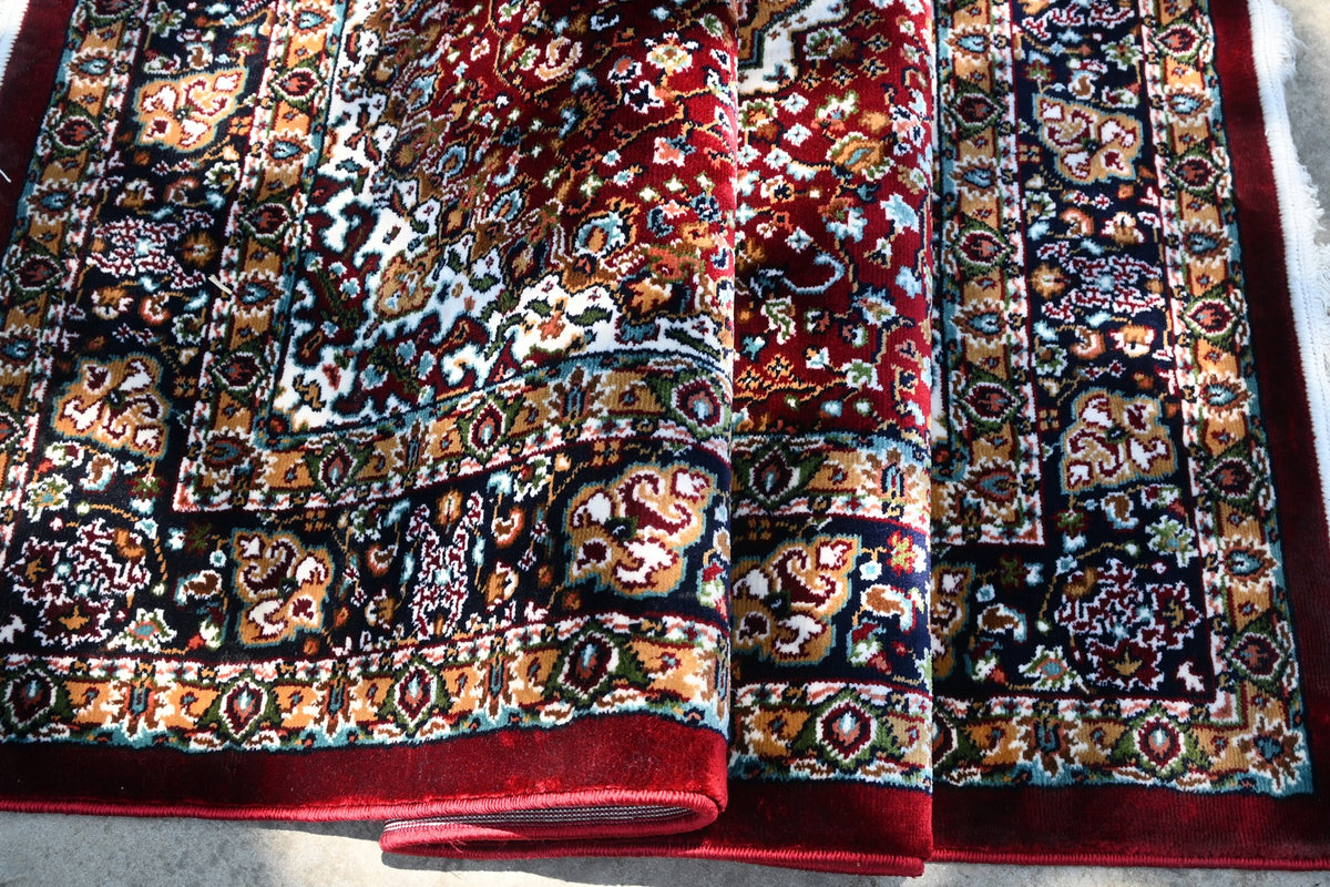 Close-up detail of the ornate floral pattern on Zebaish Traditional Carpet
