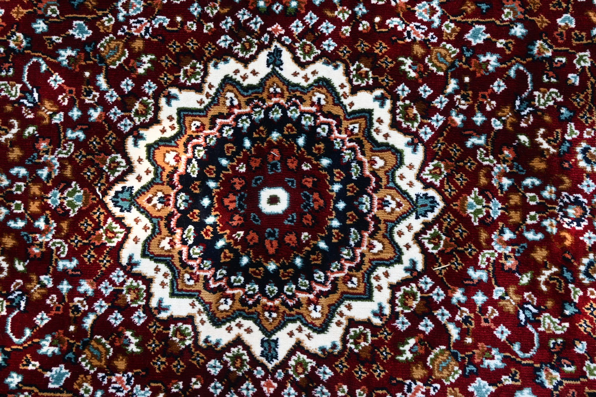 Detailed central medallion of Zebaish Traditional Carpet surrounded by intricate floral motifs