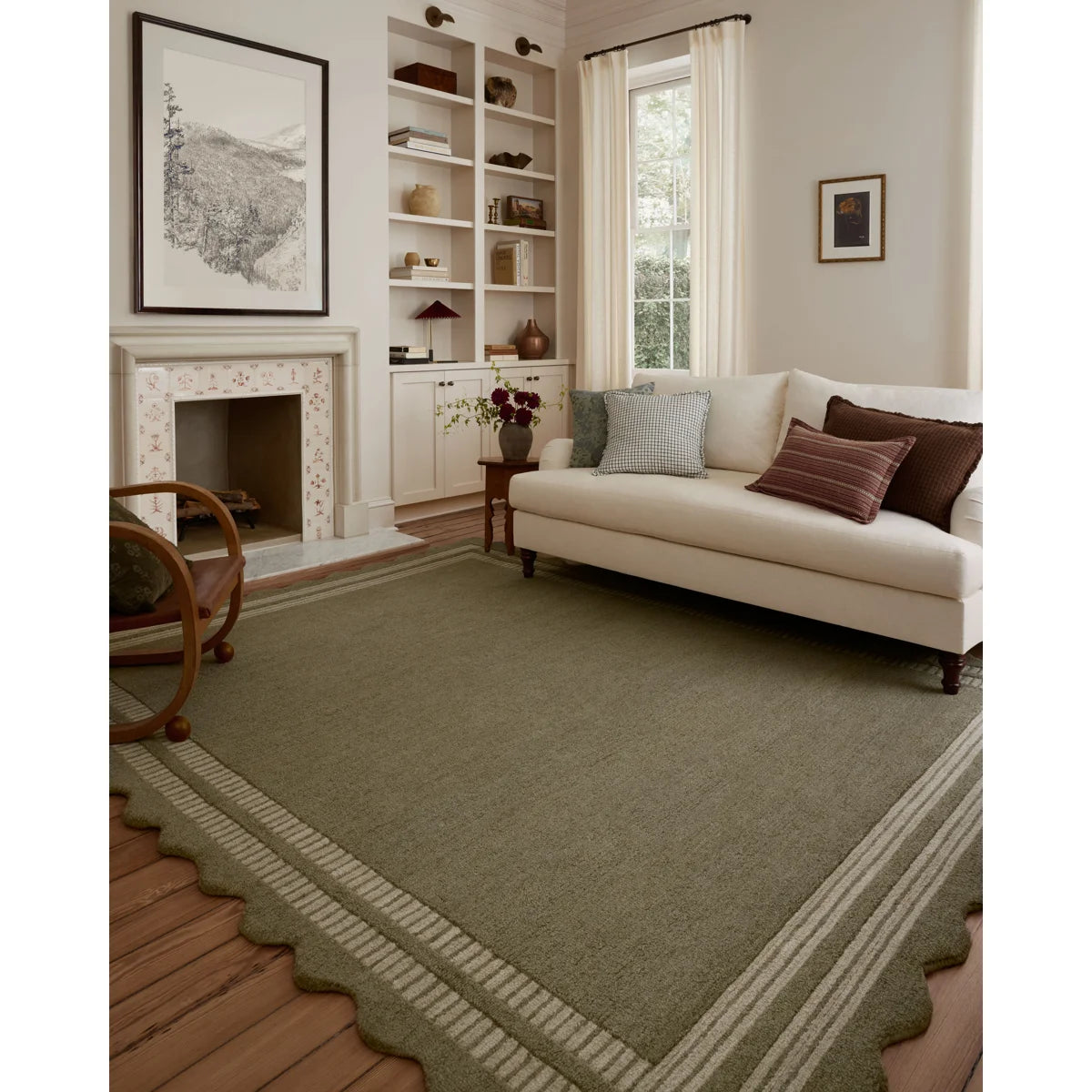 Living room with a beige sofa, green rug, and decorative elements.