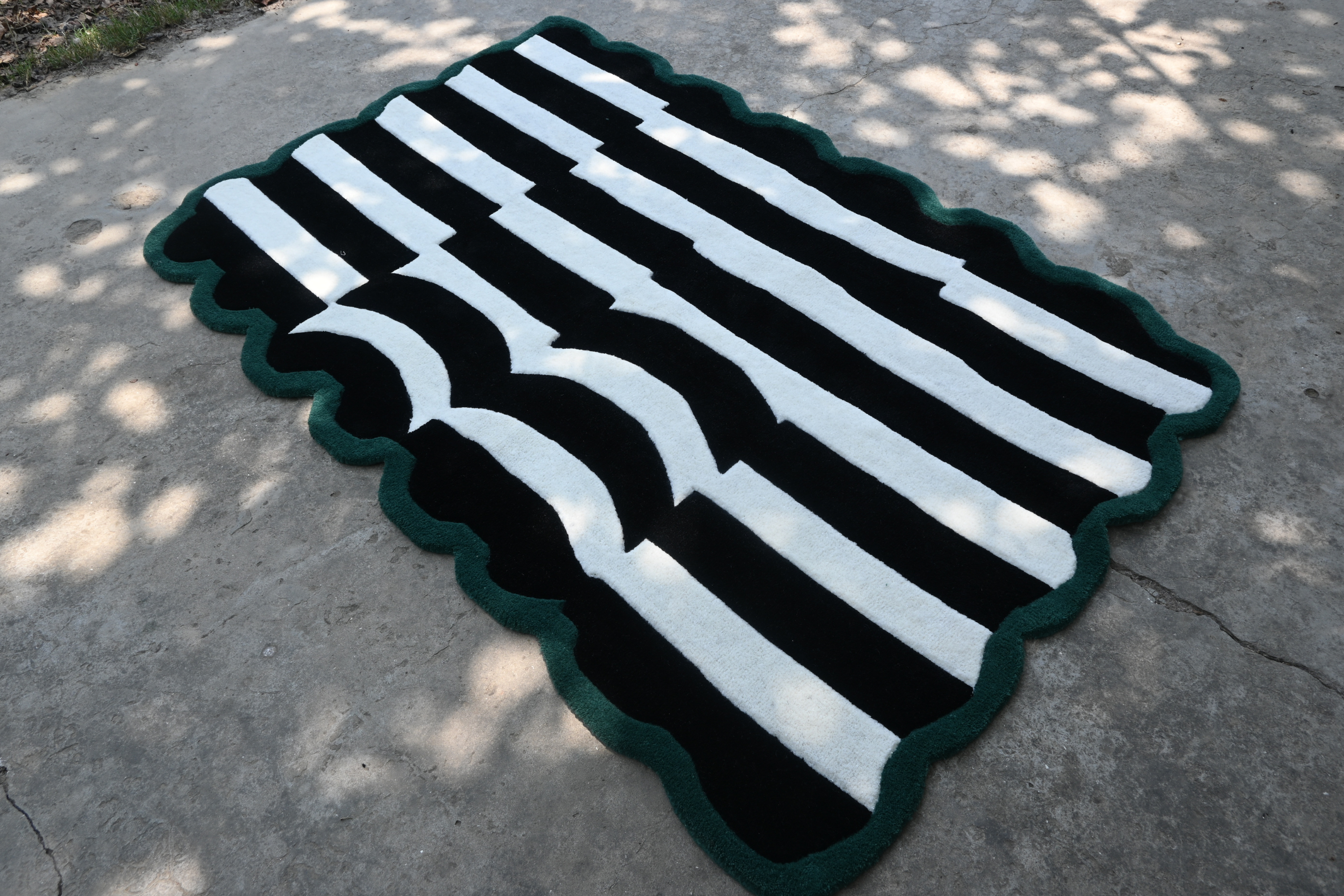 Black and white striped rug on a concrete surface