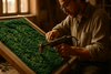 A skilled artisan hand-tufting a green rug on a wooden frame, soft natural lighting, focus on precise loops of yarn, warm earthy studio tones, detailed textures of wool, cinematic composition.