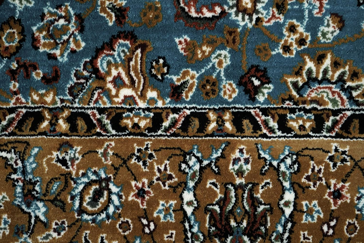 Close-up of Almas Royal Floral Rug showing blue pile and detailed floral border motifs