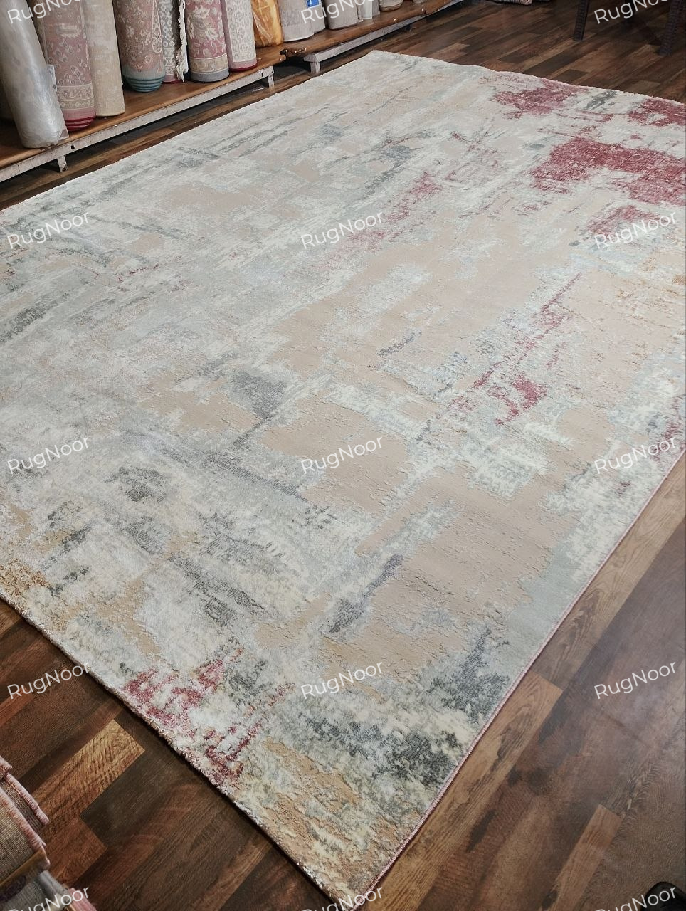 Side-angle view of the Amselle abstract rug showing its surface texture, pile and edge profile.