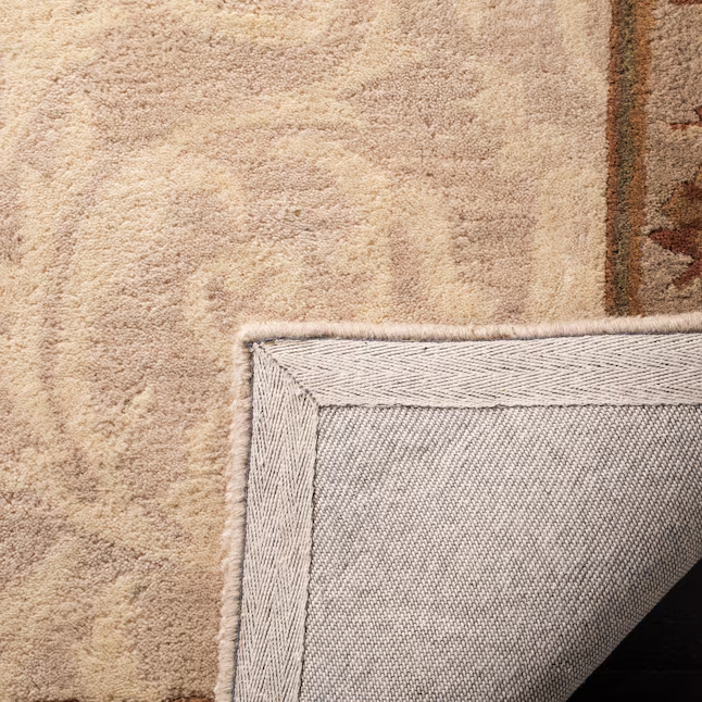 Close-up of Arenza hand-tufted wool rug showing its soft pile, woven backing, and finished edge