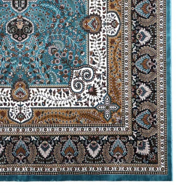 Arezou Royal Medallion Rug detail showing the blue field, ivory border, tan accents and dark patterned outer border