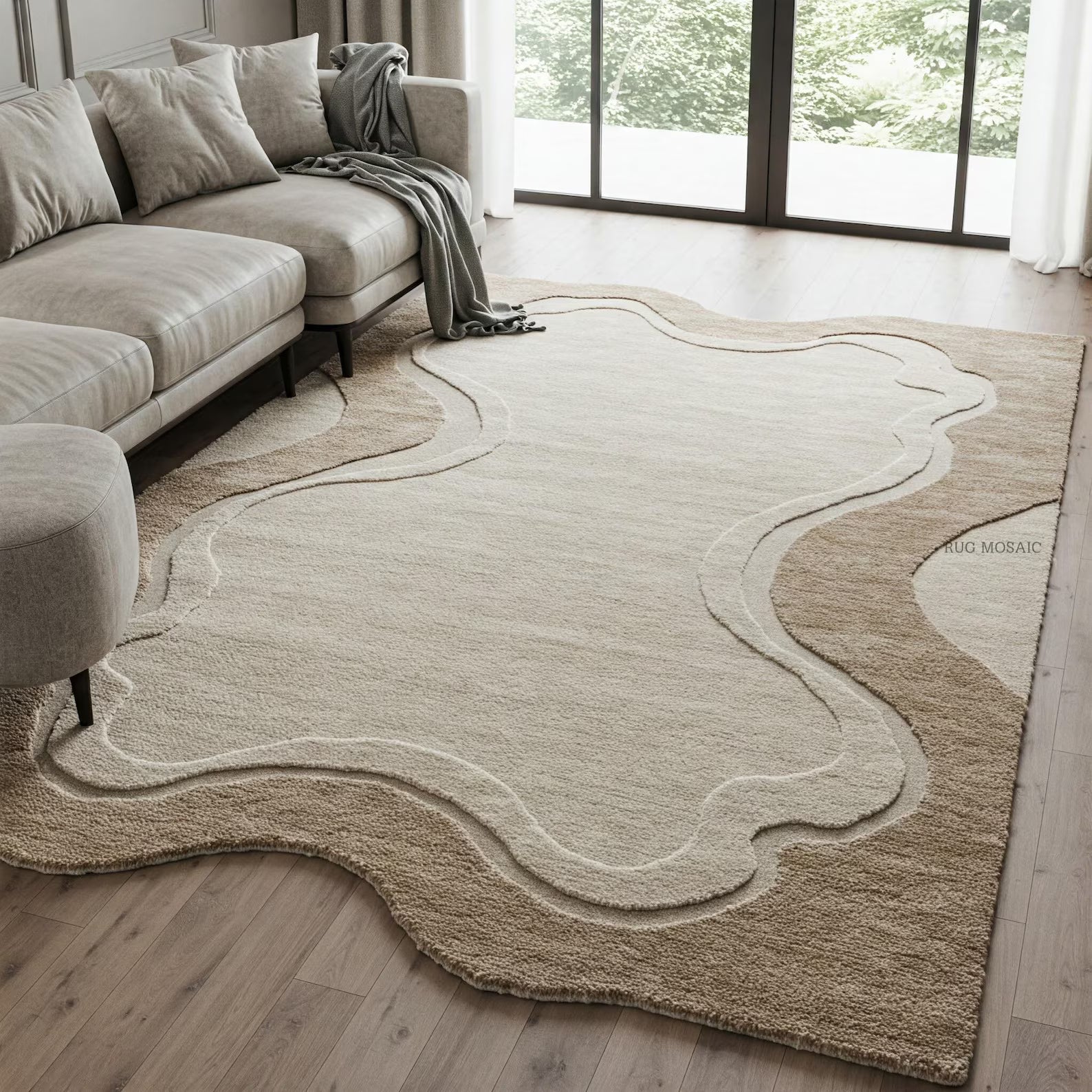 An abstract, organic-shaped area rug in shades of beige and cream, styled on a light wood floor in a modern living room with a sofa and large windows.