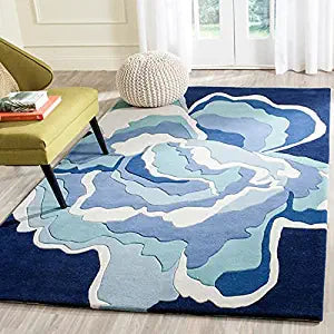 Hand-tufted blue and beige floral wool area rug styled in a modern living room