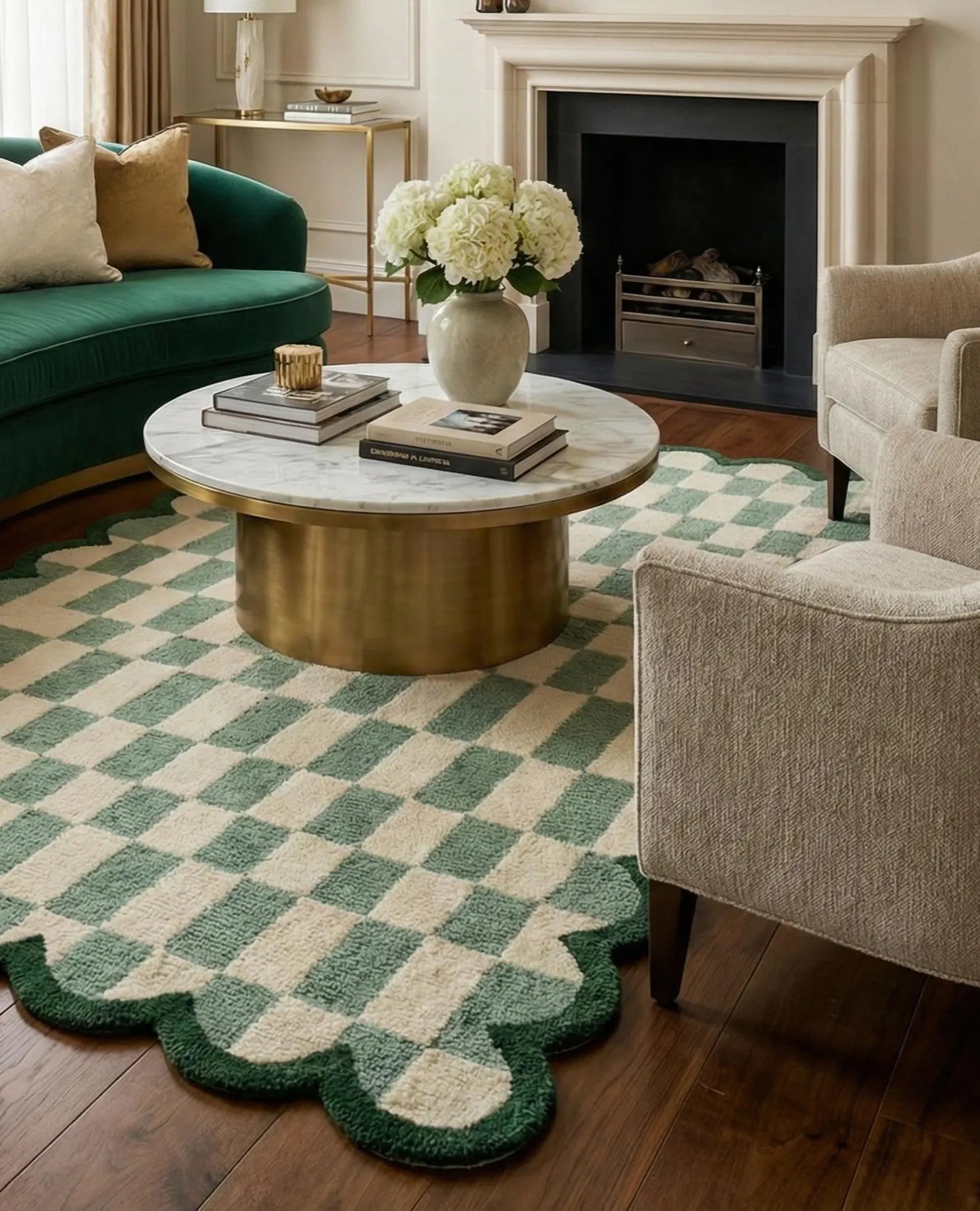 A green and cream checkered area rug with a scalloped edge, styled in a cozy living room with a marble-top coffee table, green sofa, and beige armchair.