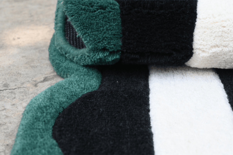 Hand-tufted green, black and white striped rug – close-up pile texture, RugNoor