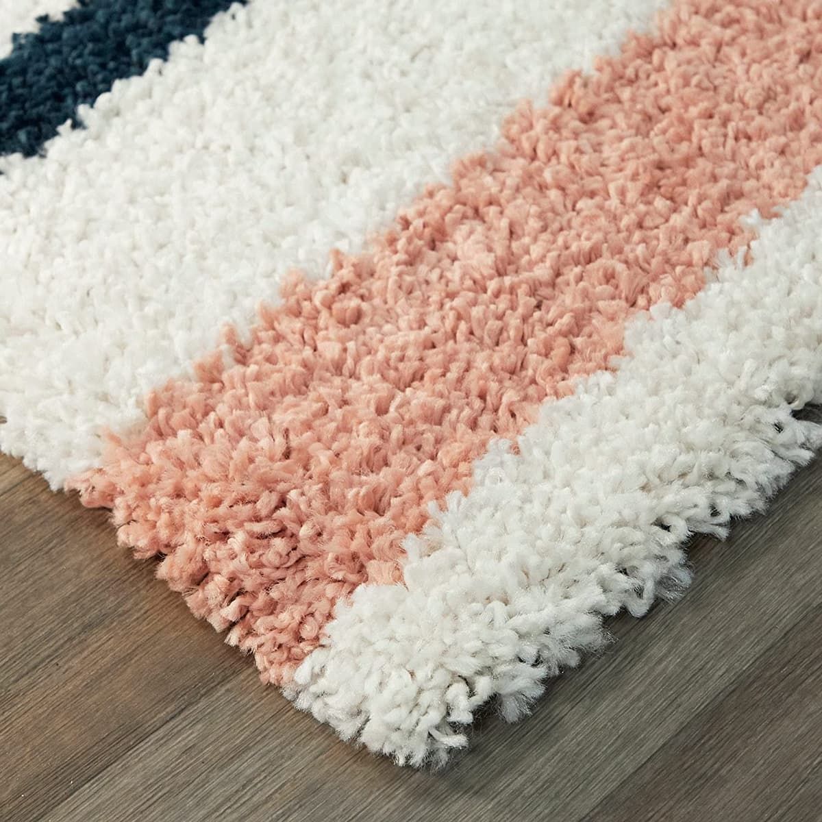 Multicolored textured rug on a wooden floor