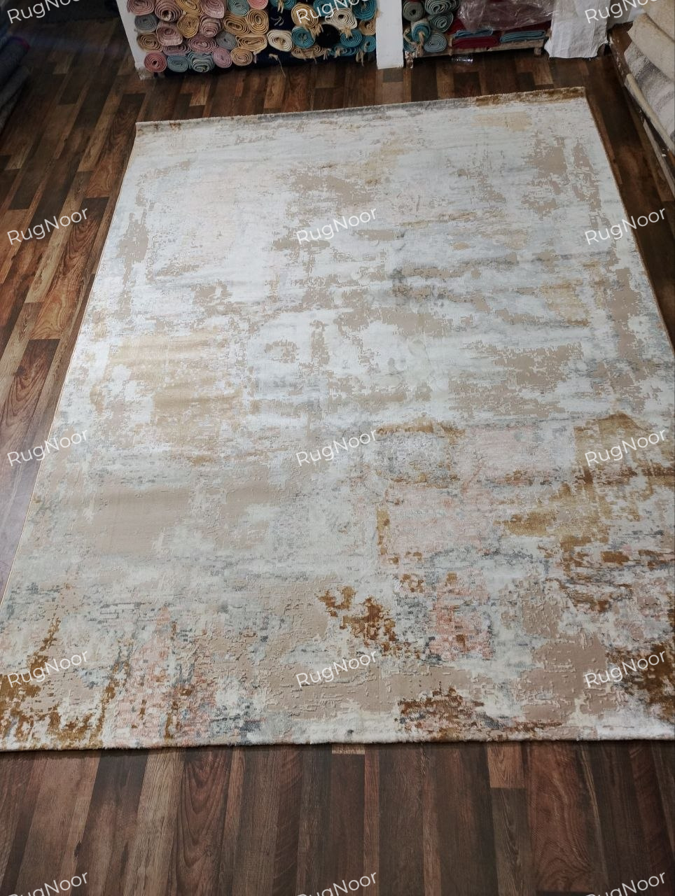 8x11 ft modern abstract rug in beige, ivory, taupe, muted rust and grey-blue, featuring a distressed pattern.