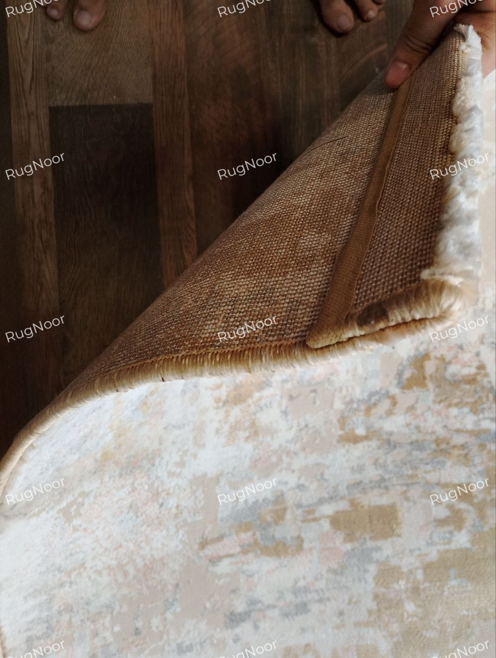 Lifted corner of the Crossfade rug showing the 12 mm pile, surface texture and underside.