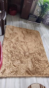 arge beige fluffy fur rug on white floor in furnished living room