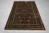 Firman Persian rug flat lay showing complete deep crimson field with forest green border and ivory fringe
