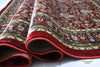 Firman Persian rug folded showing soft acrylic wool pile, green-gold border detail and plush comfortable texture