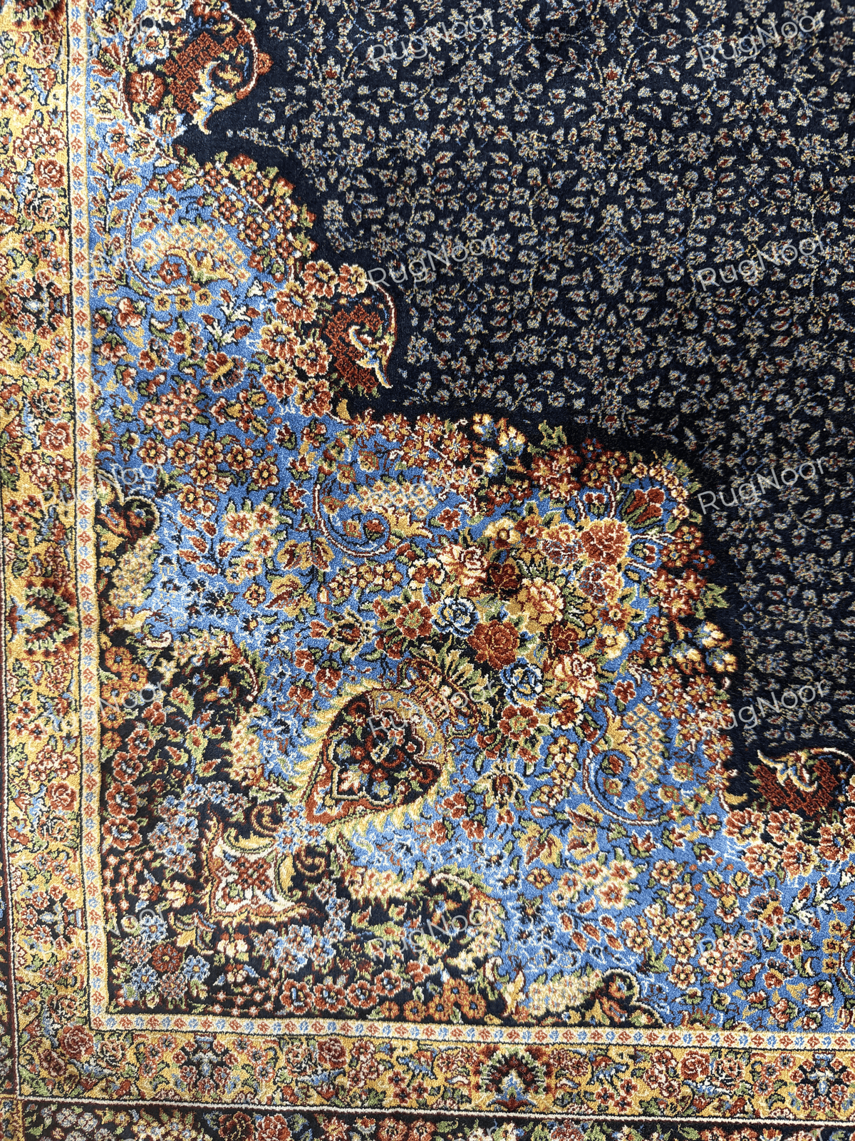 Detailed view of the floral corner and decorative border against the navy blue field by RugNoor