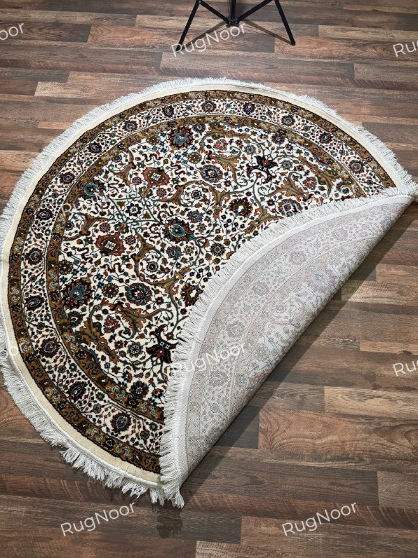 Folded corner of Zarqaya round traditional floral rug showing the patterned underside and ivory fringe - RugNoor