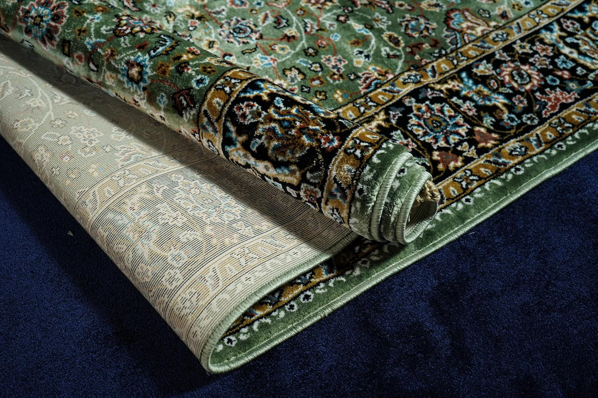 Golshan Royal Floral Rug rolled to show the backing, finished edge and ornamental border