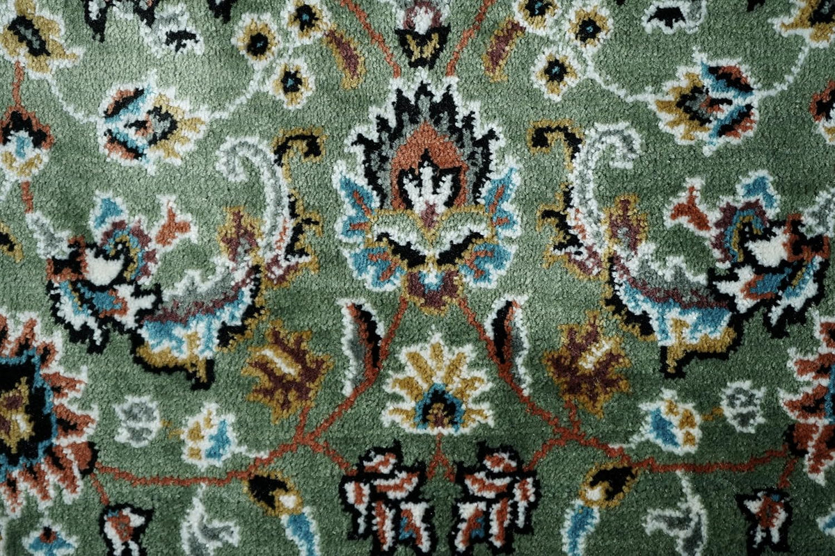 Golshan Royal Floral Rug close-up showing detailed floral motifs on the green field