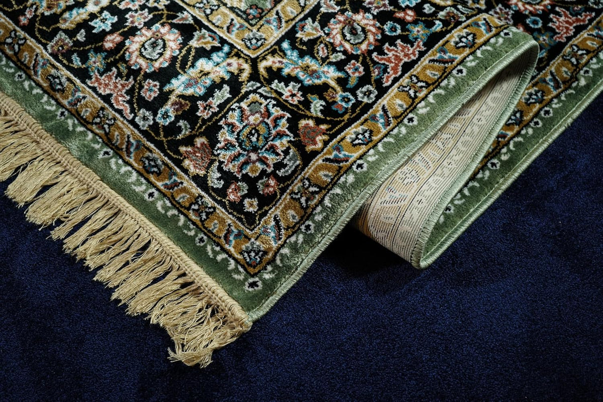 Golshan Royal Floral Rug folded to show the floral border, fringe and finished edge