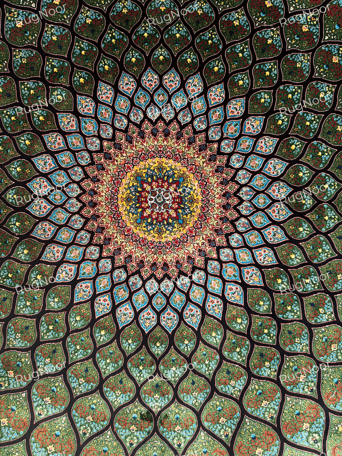 Close-up of the radiating central medallion and dense turquoise, red, yellow and ivory patterning.