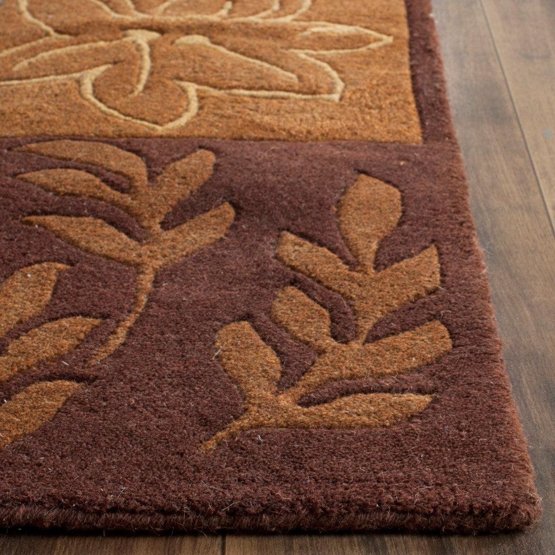 Close-up of Harvest Patchwork wool rug showing its plush textured pile and raised botanical leaf pattern