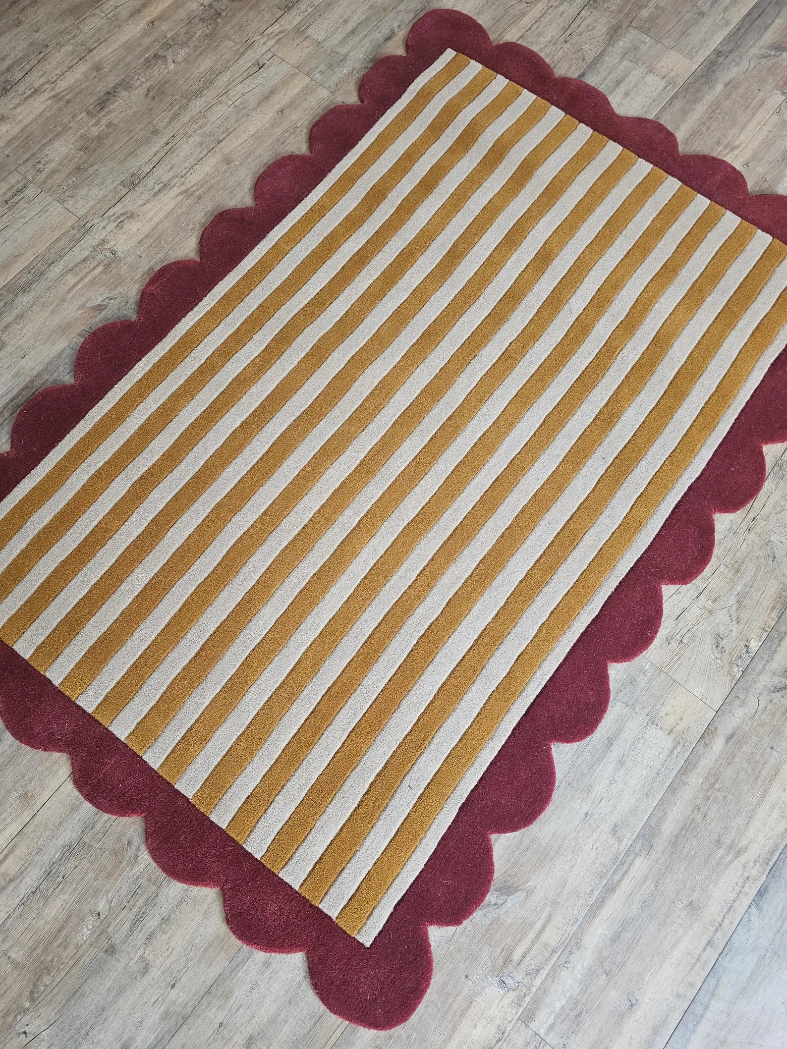scalloped rug in mustard stripes