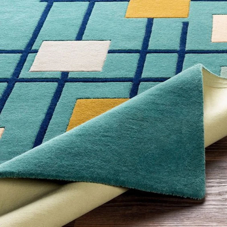 Edge and pile thickness view of wool rug showing fine hand tufted quality