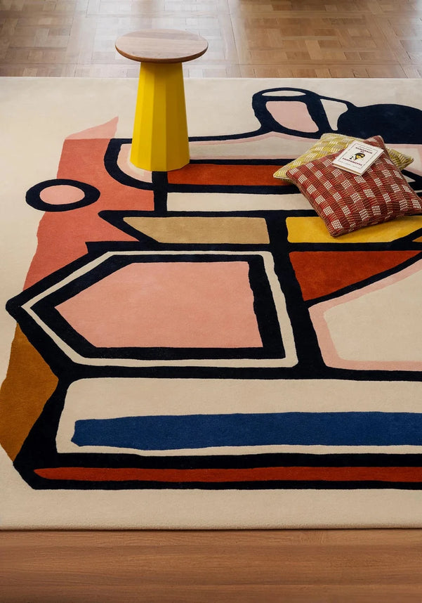 Modern hand tufted designer rug under coffee table with decor elements