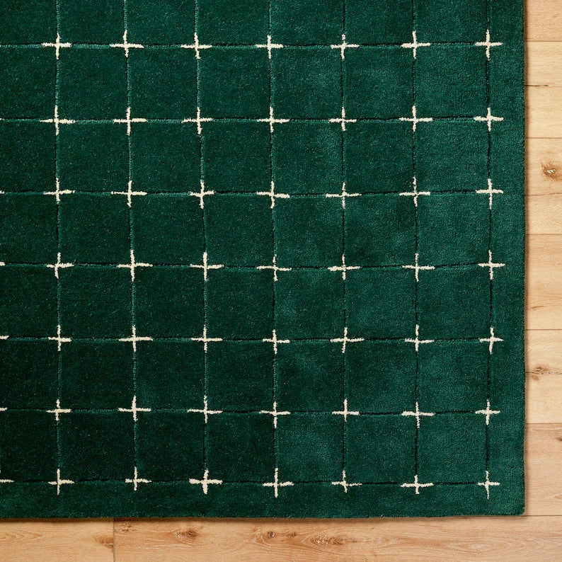 Detailed view of white grid pattern on plush green wool rug