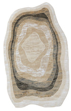 An abstract oval area rug with concentric organic shapes in cream, beige, tan, brown, and charcoal gray, shown flat against a white background.