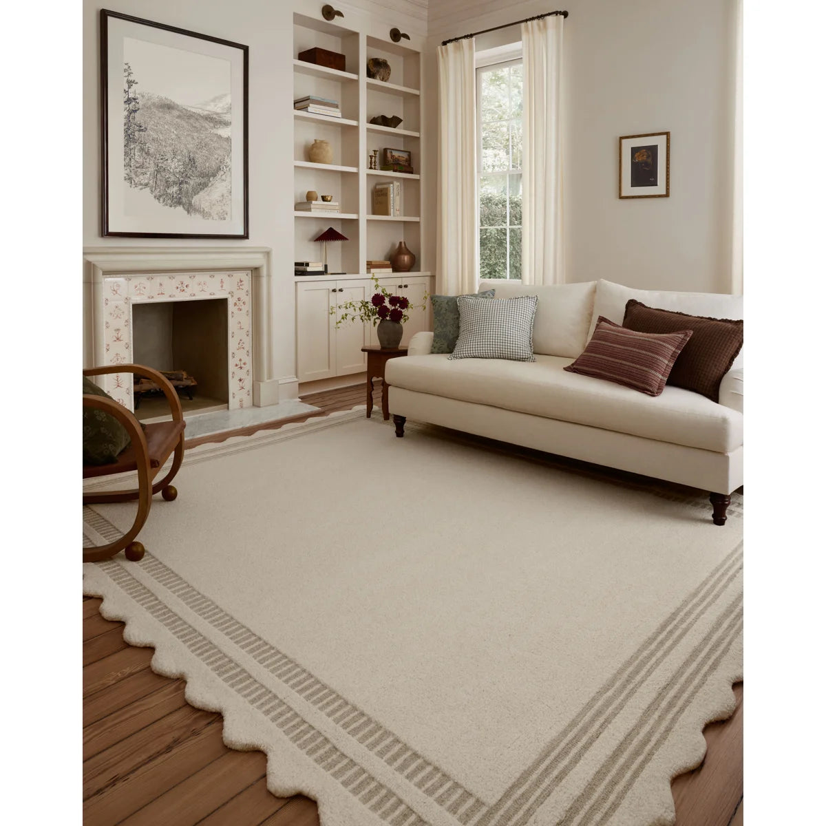 Living room with a white sofa, fireplace, and decorative elements.
