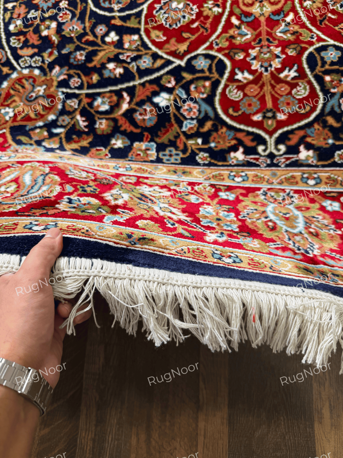 Close-up of Jouri rug's red floral border, gold detailing and ivory fringe - RugNoor