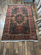 Full view of Jouri rug with navy field, red floral borders and ivory fringe - RugNoor